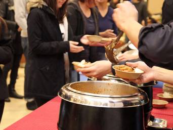 熱々カレーをスタッフがサーブ